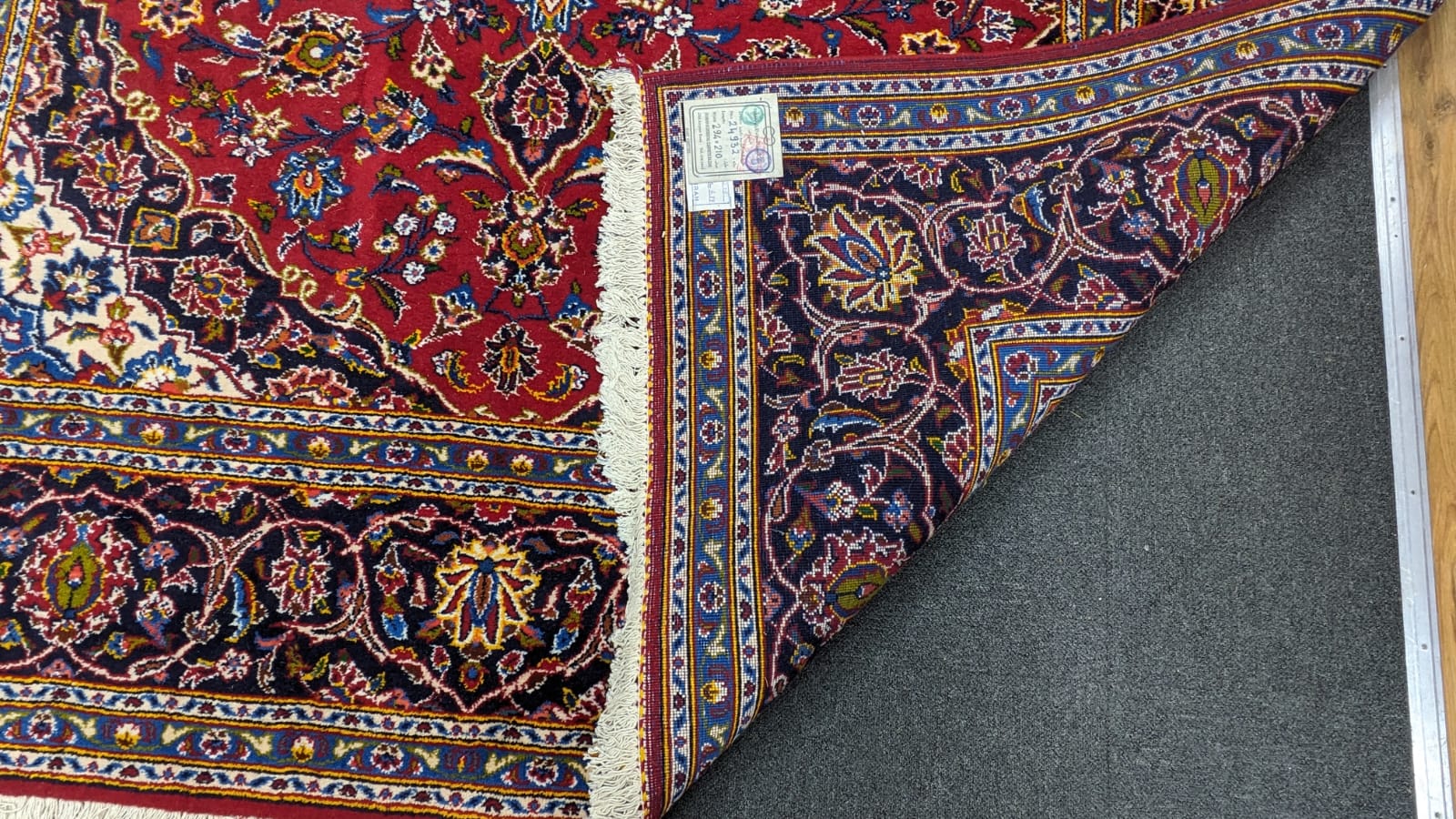 A Tabriz burgundy ground carpet, 292 x 216cm